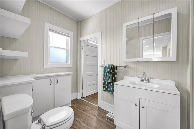 a bathroom with a sink toilet and vanity