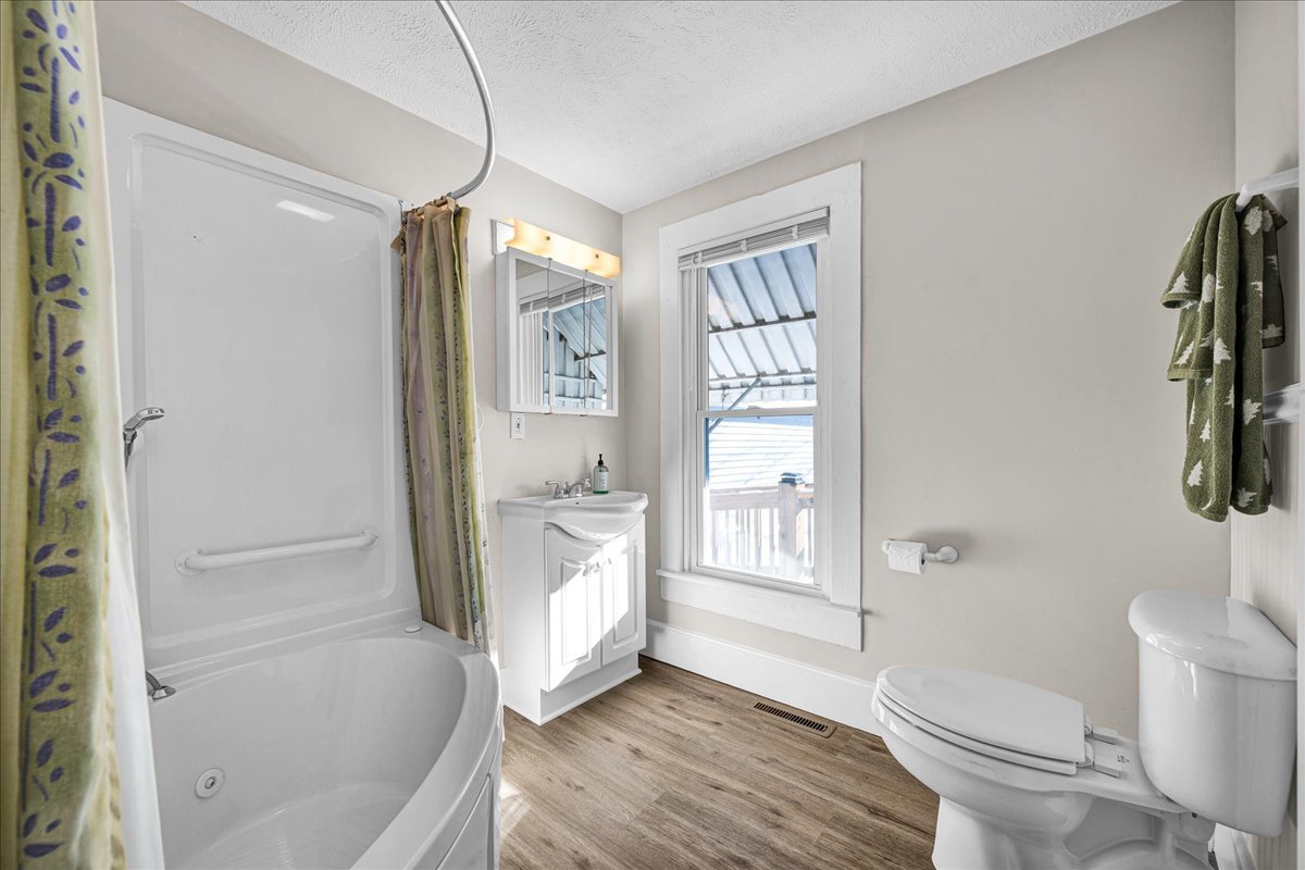 1406 West Walnut Street Bloomington, IL 61701 - Photo 22 of 32 a bathroom with a tub toilet and sink