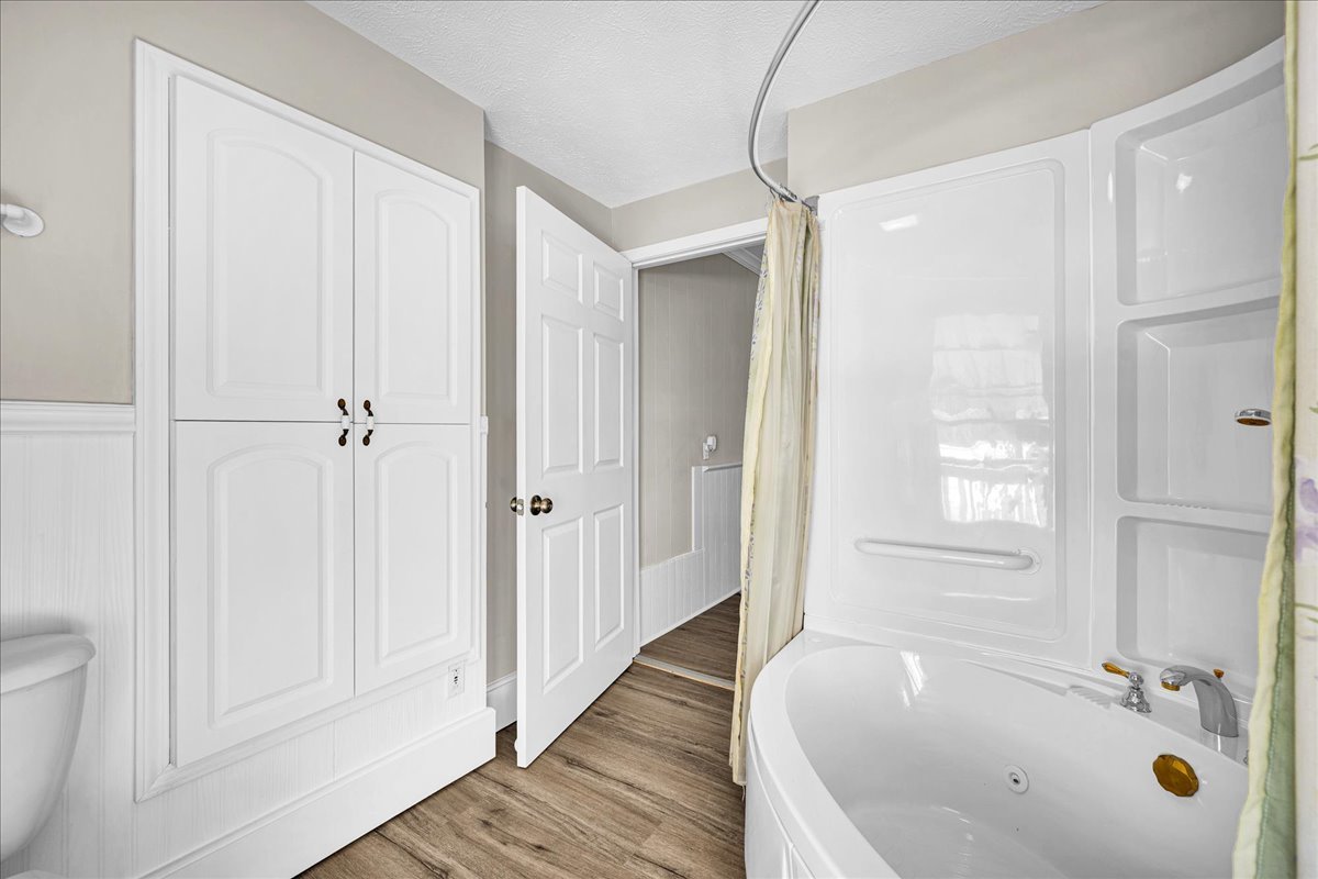 1406 West Walnut Street Bloomington, IL 61701 - Photo 23 of 32 a bathroom with a tub shower and a sink