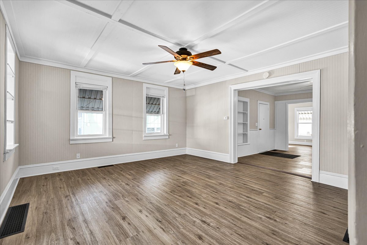 1406 West Walnut Street Bloomington, IL 61701 - Photo 4 of 32 a view of an empty room with window and wooden floor