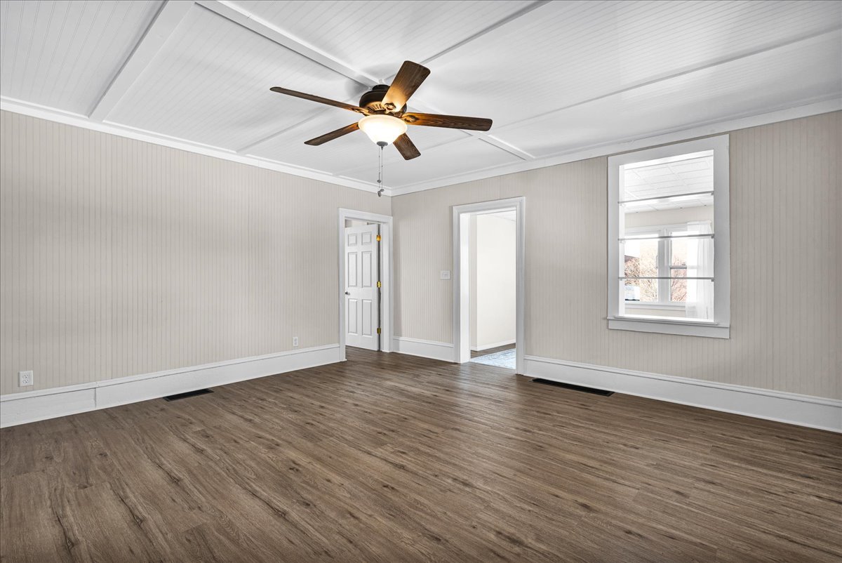 1406 West Walnut Street Bloomington, IL 61701 - Photo 5 of 32 a view of an empty room with wooden floor and a window