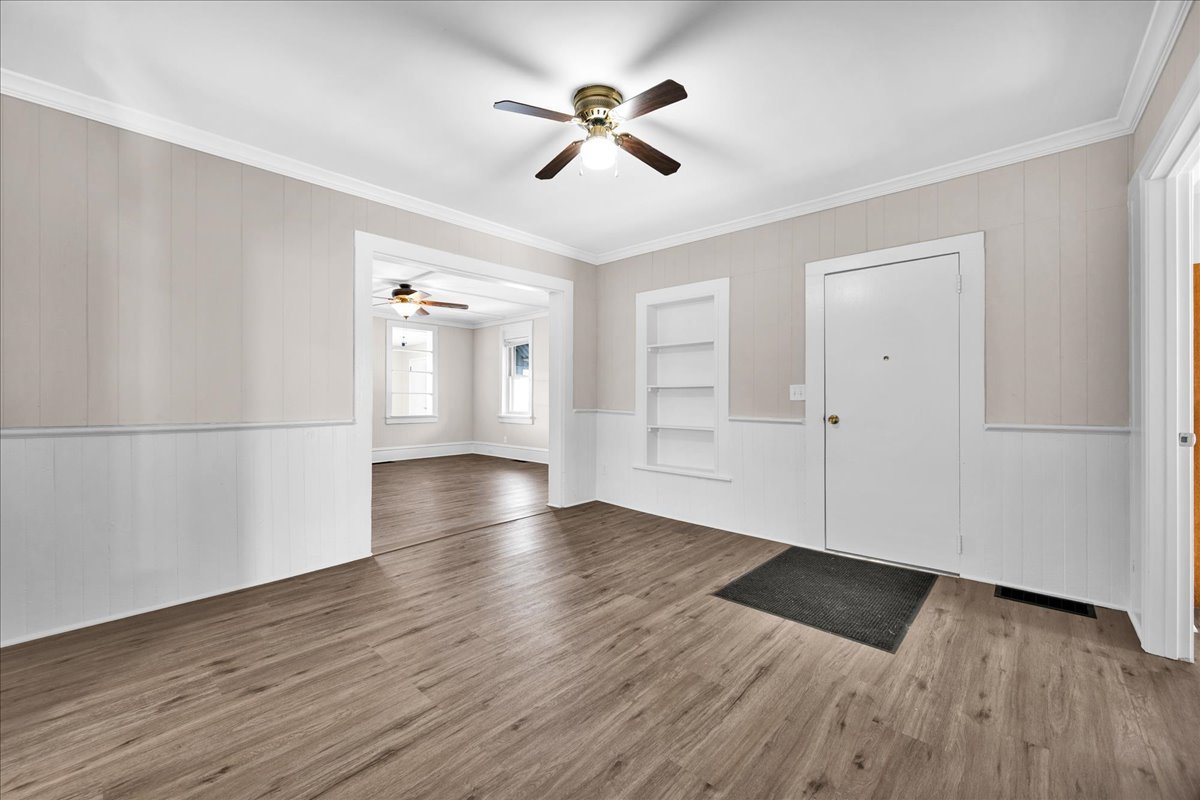1406 West Walnut Street Bloomington, IL 61701 - Photo 7 of 32 an empty room with wooden floor and windows