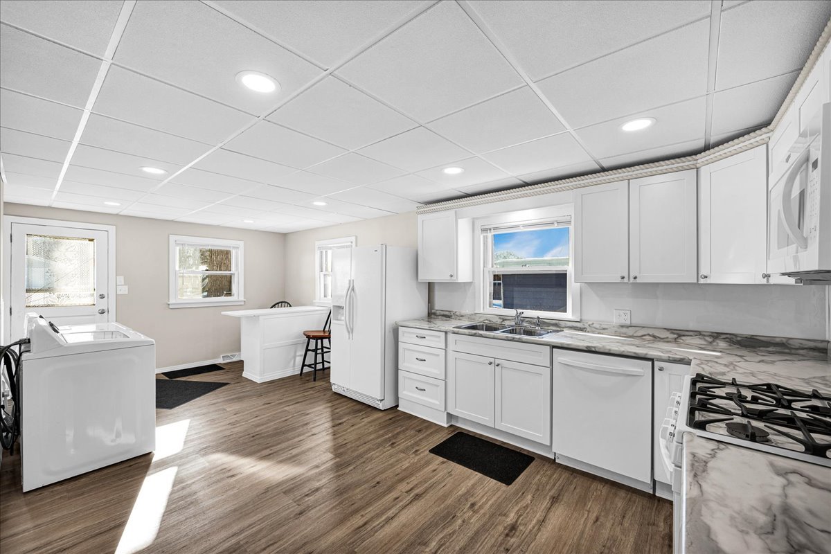 1406 West Walnut Street Bloomington, IL 61701 - Photo 8 of 32 a open kitchen with stainless steel appliances granite countertop a stove and white cabinets
