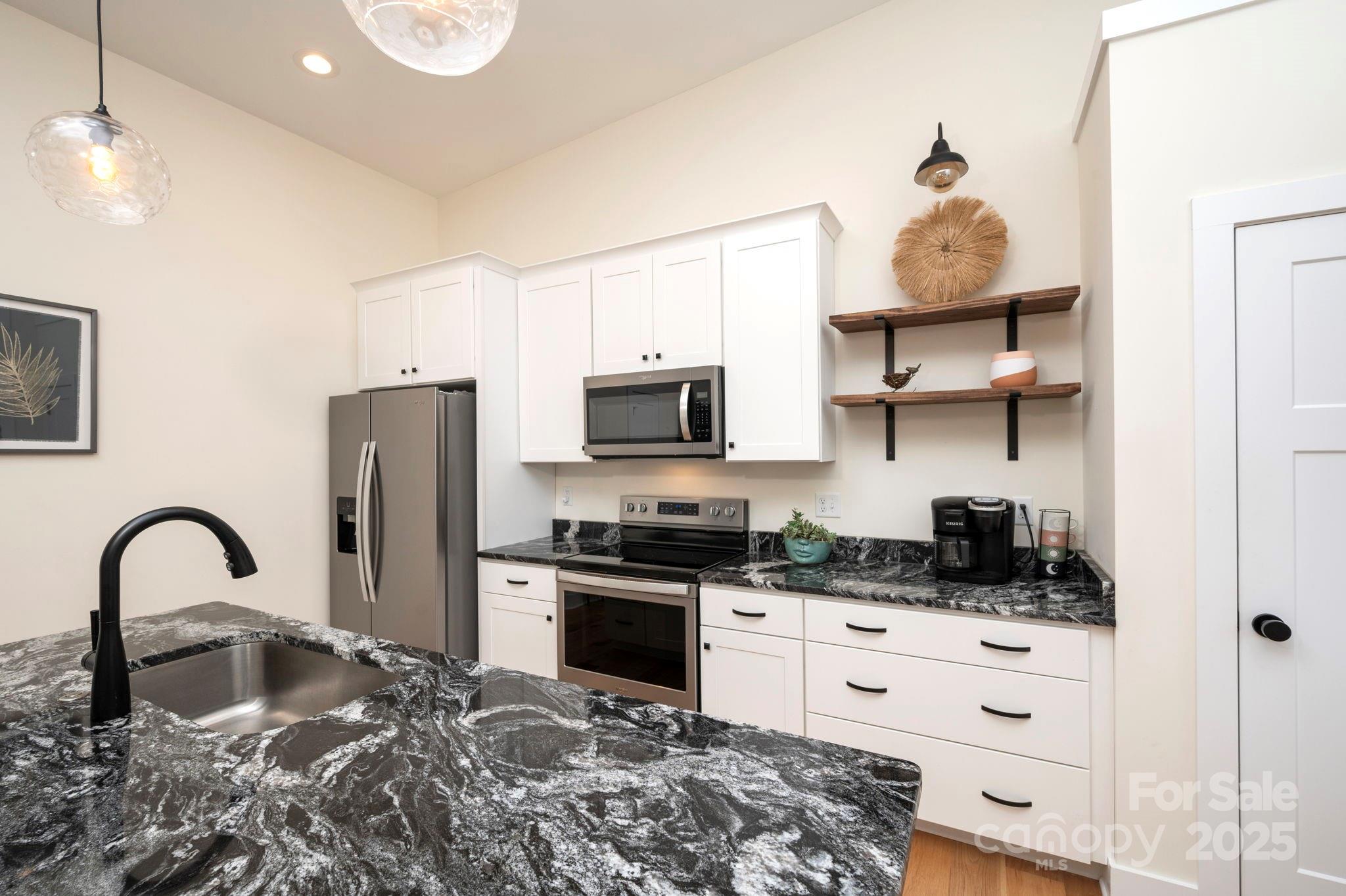 20 Garden Road Asheville, NC 28804 - Photo 13 of 44 a kitchen with stainless steel appliances granite countertop a stove a sink and a refrigerator