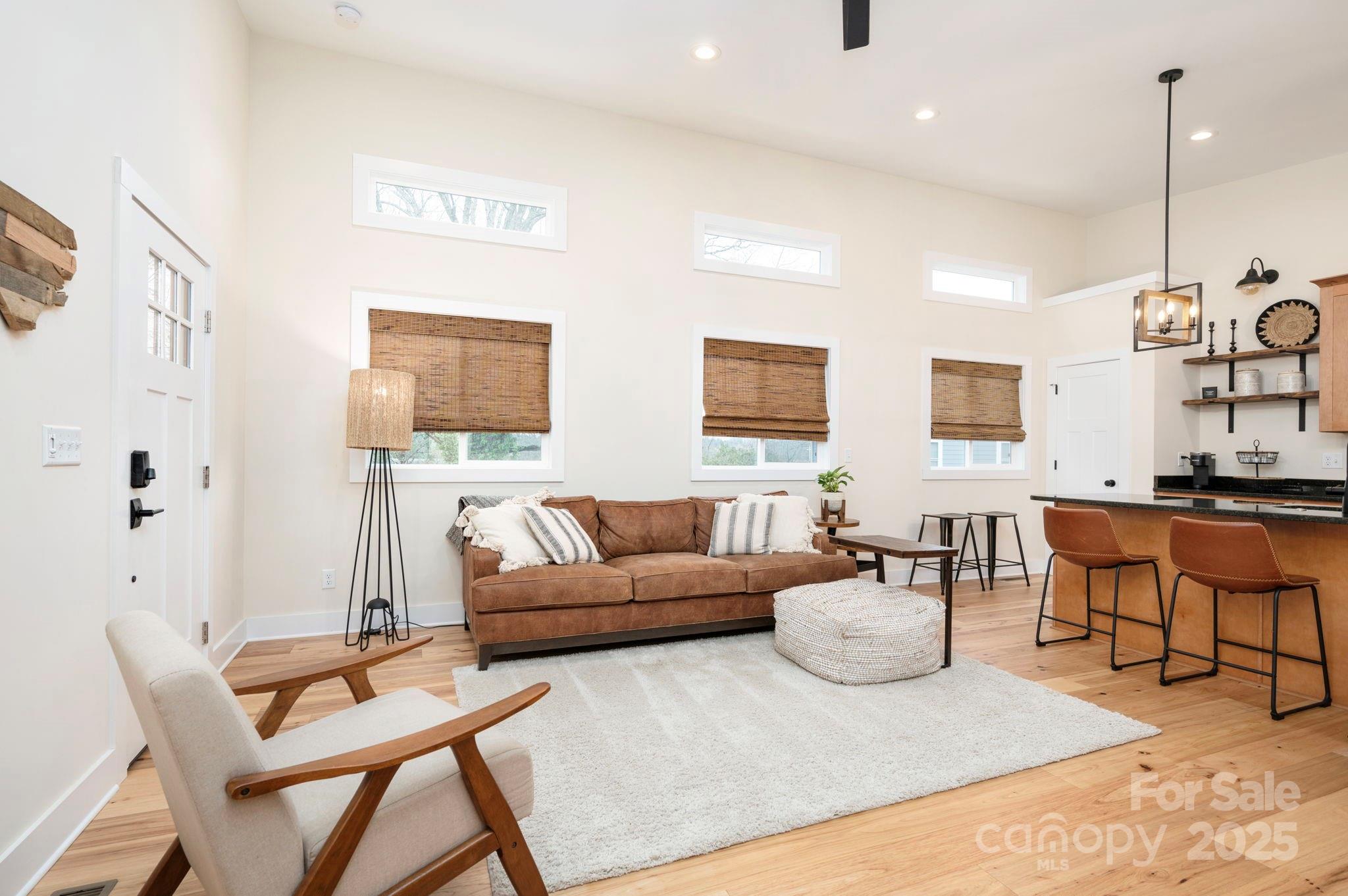 20 Garden Road Asheville, NC 28804 - Photo 29 of 44 a living room with furniture a rug and a chandelier