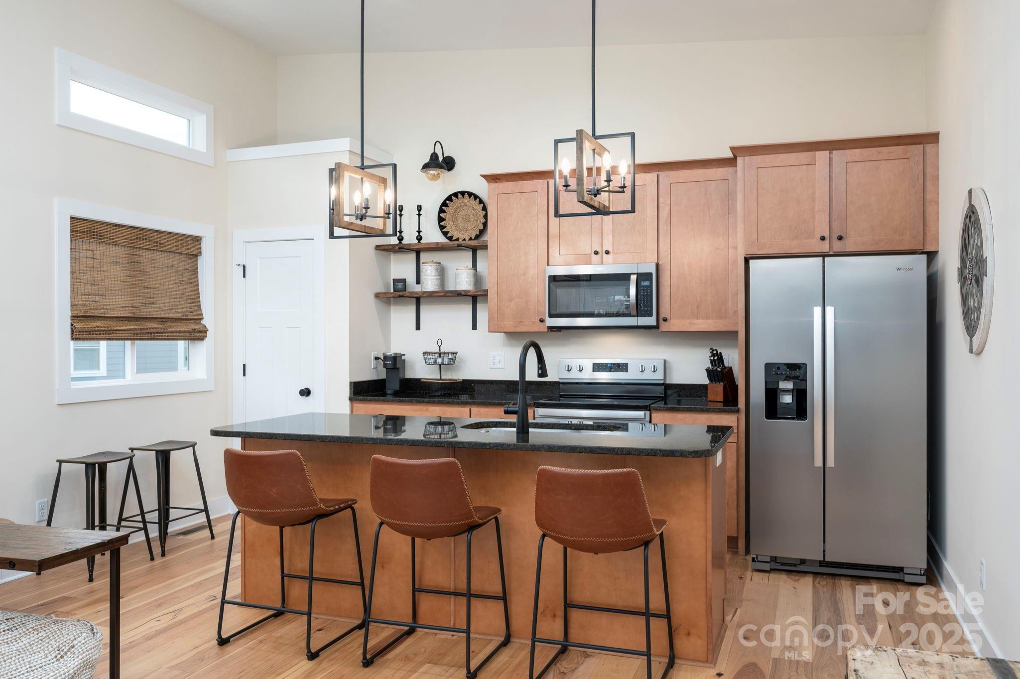 20 Garden Road Asheville, NC 28804 - Photo 30 of 44 a kitchen with stainless steel appliances granite countertop a sink a stove a refrigerator and island with wooden floor