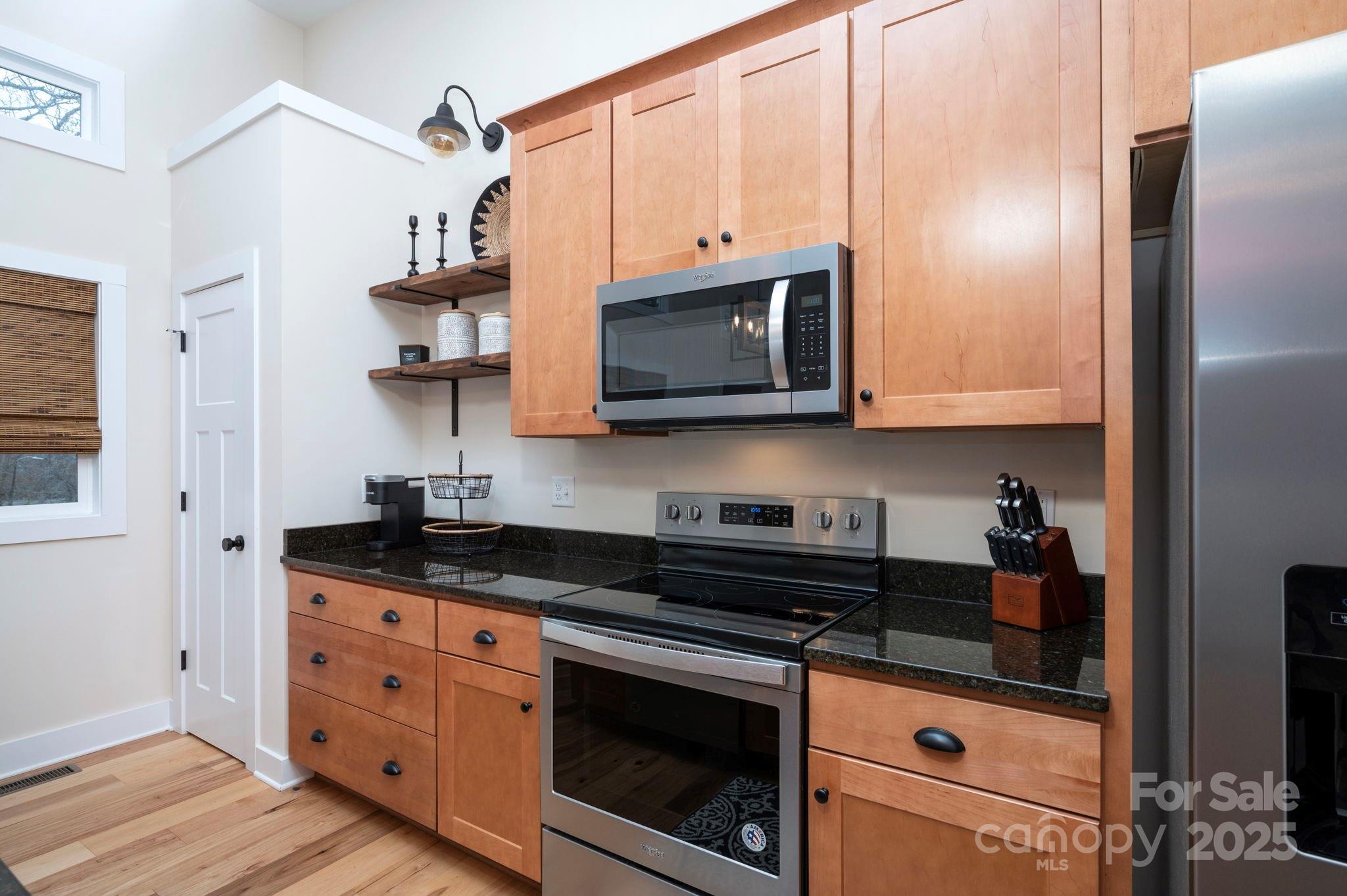 20 Garden Road Asheville, NC 28804 - Photo 32 of 44 a kitchen with granite countertop white cabinets stainless steel appliances and a sink