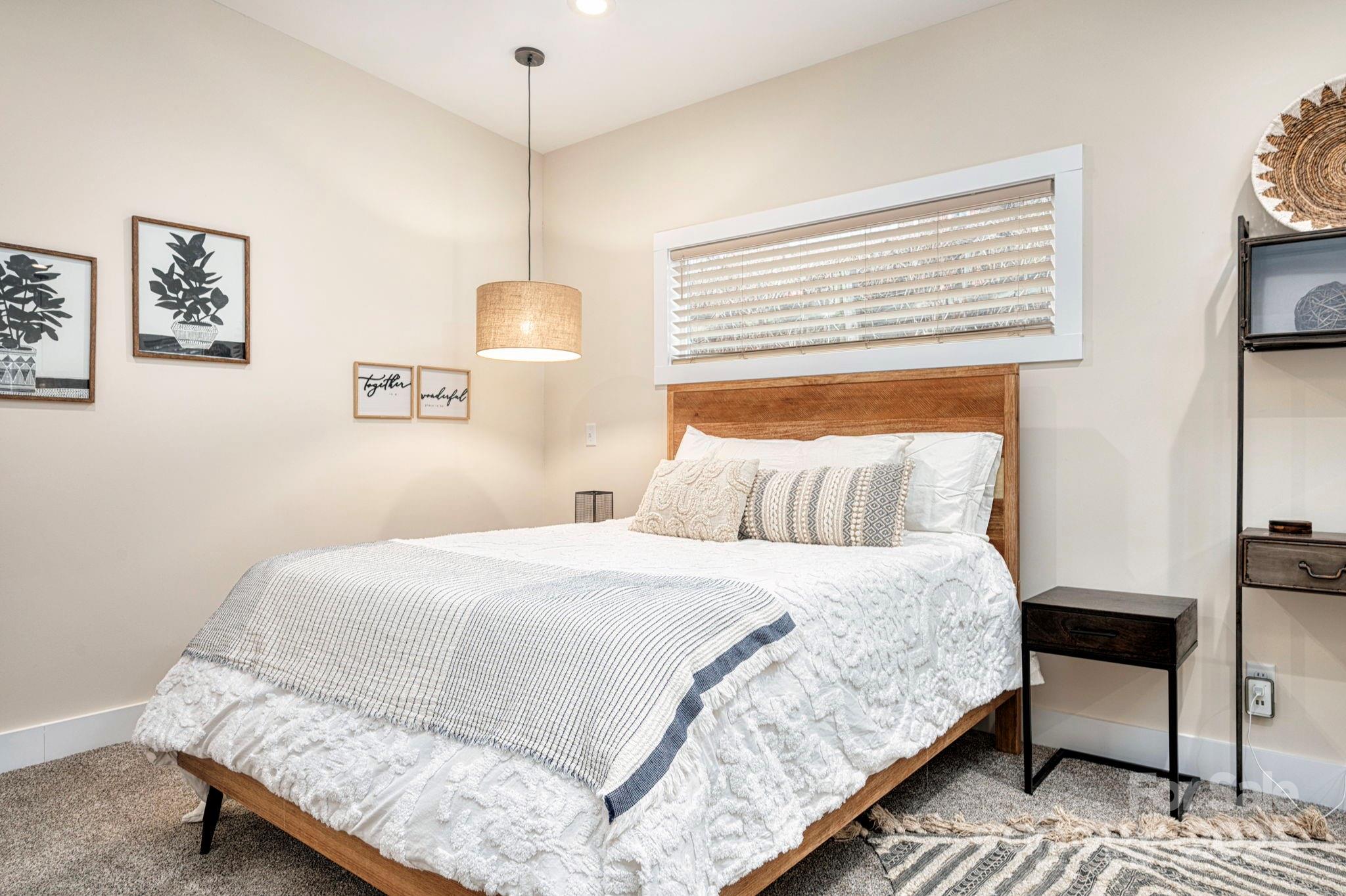 20 Garden Road Asheville, NC 28804 - Photo 37 of 44 a bedroom with a bed a rug and chair
