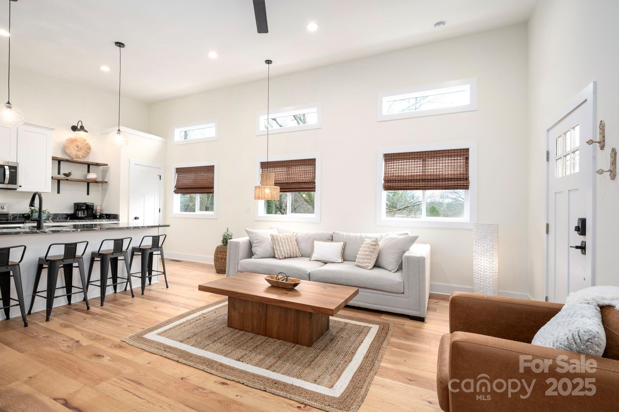 20 Garden Road Asheville, NC 28804 - Photo 8 of 44 a living room with furniture wooden floor and a view of kitchen
