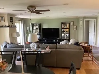 a view of a dining room with furniture and wooden floor
