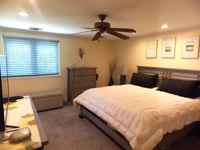 a bedroom with a bed and a desk