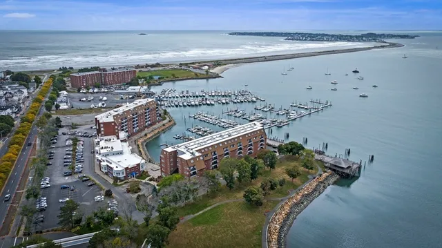 a kitchen with kitchen island granite countertop a sink counter top space appliances and cabinets