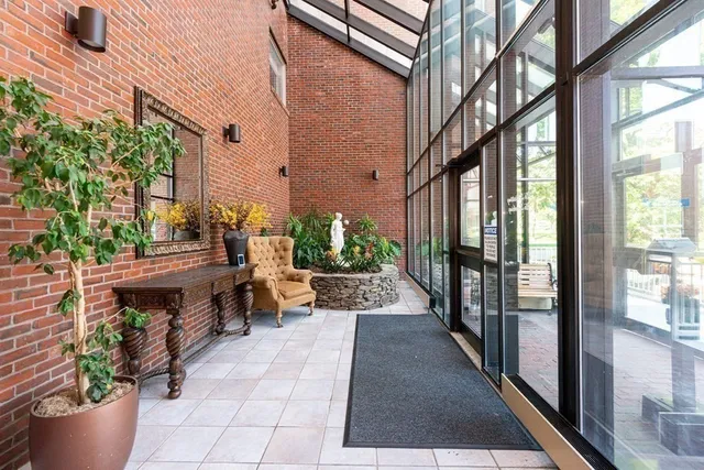 a living room with furniture and a floor to ceiling window
