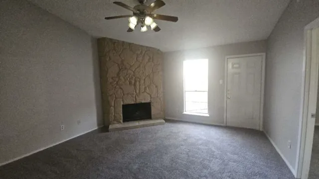 a view of empty room with a fireplace