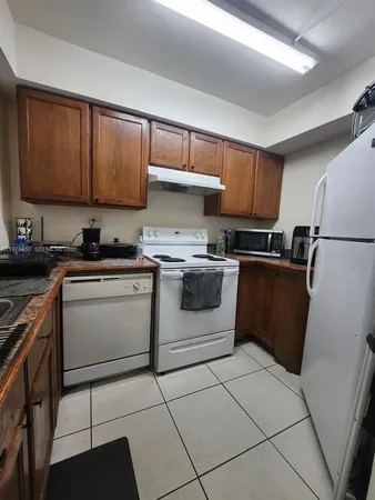 a kitchen with a stove sink and a refrigerator