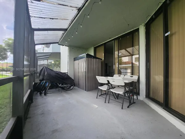 a backyard of a house with table and chairs