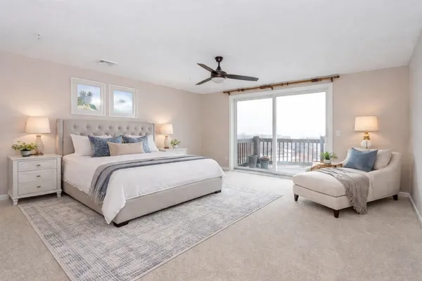 a bedroom with bed and large window