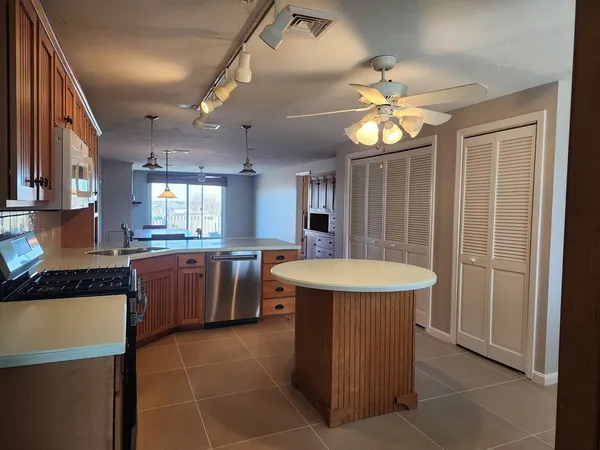 a kitchen with cabinets and window