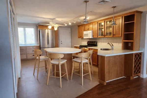 a dining table with chairs and window