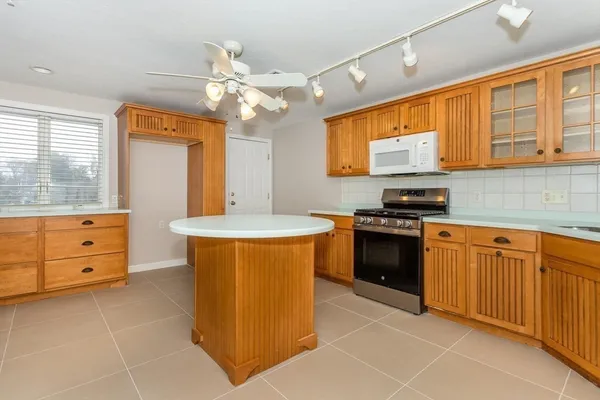 a kitchen with stainless steel appliances granite countertop a stove a sink and a refrigerator