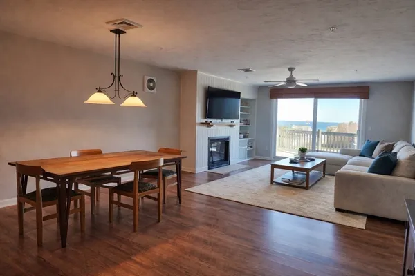 a living room with furniture a flat screen tv and a large window