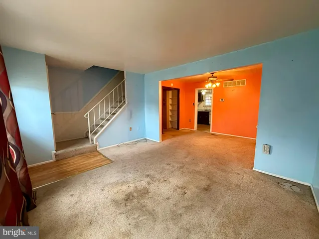 an empty room with closet and fan