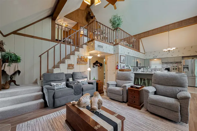 a living room with furniture and a chandelier