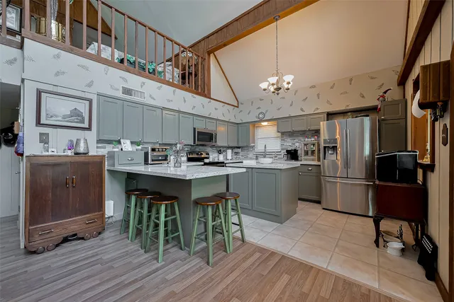 a kitchen with refrigerator cabinets and wooden floor