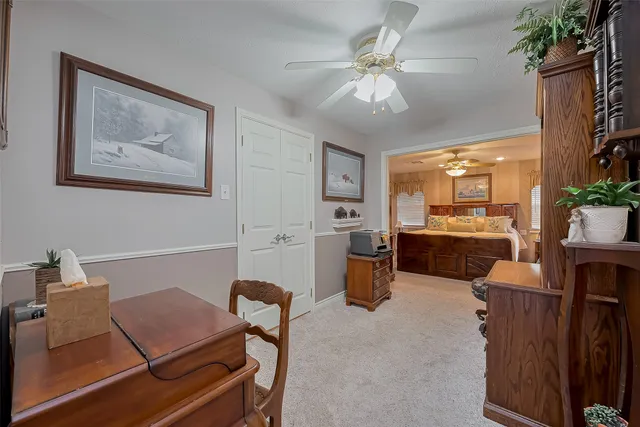 a living room with furniture a chandelier and a dining room