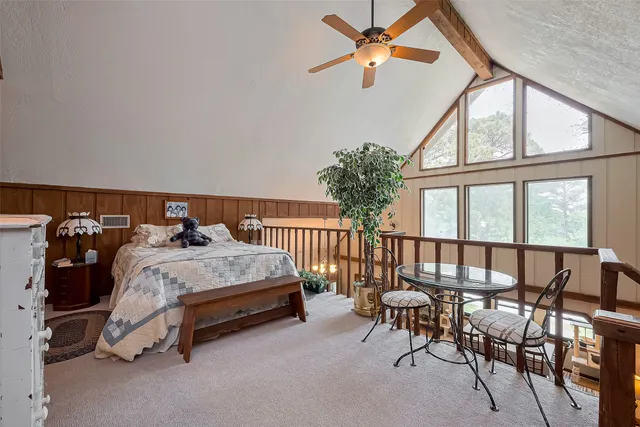 a bed sitting in a bedroom next to a window