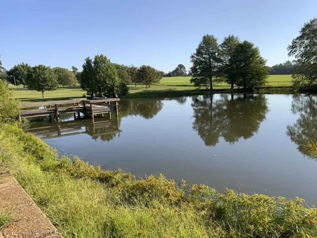 a view of lake with table and chairs