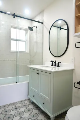 a bathroom with a sink mirror toilet and bathtub
