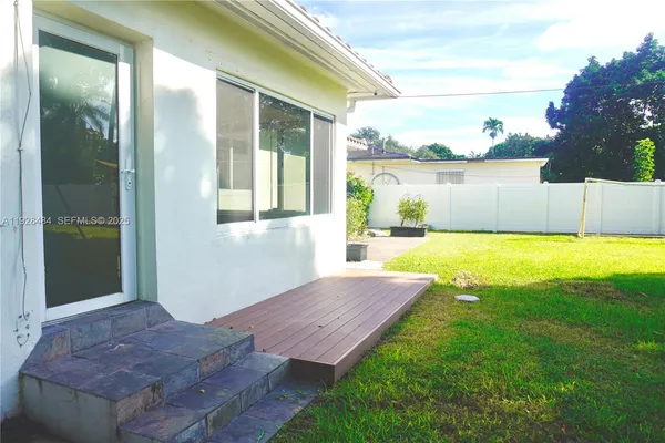 a view of a house with swimming pool and a yard