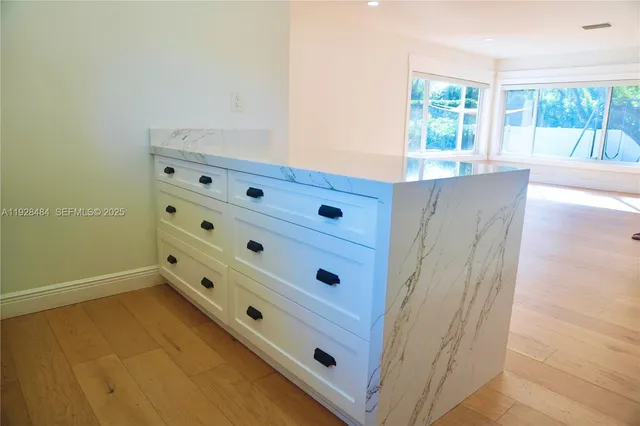 a view of wooden floor and windows in a room