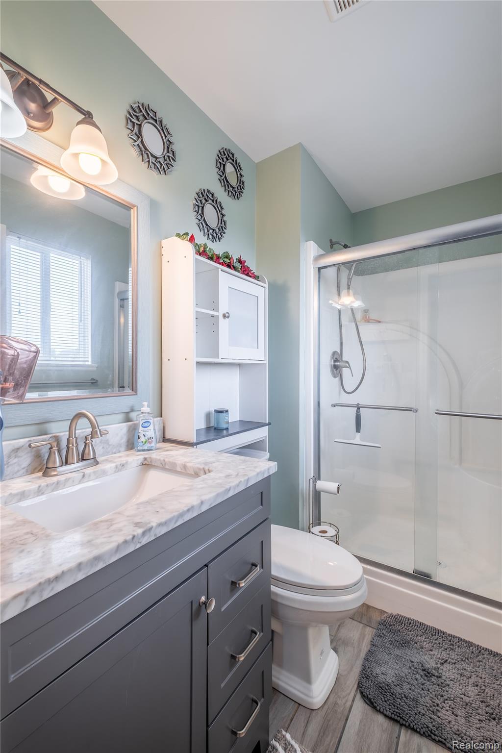 13063 Seymour Road Gaines, MI 48436 - Photo 17 of 29 Single vanity with a white basin sink, polished chrome faucet, and stone-finish countertop
