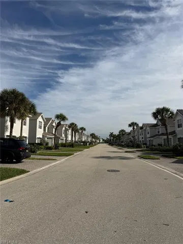 a front view of a house with a yard and parking space