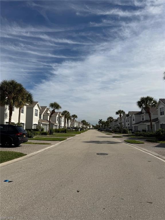 16250 Ravina Way, Unit 87 Naples, FL 34110 - Photo 13 of 15 a front view of a house with a yard and parking space