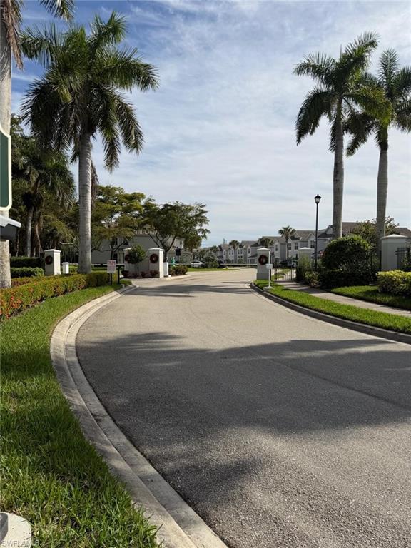 16250 Ravina Way, Unit 87 Naples, FL 34110 - Photo 14 of 15 a view of a yard with palm trees