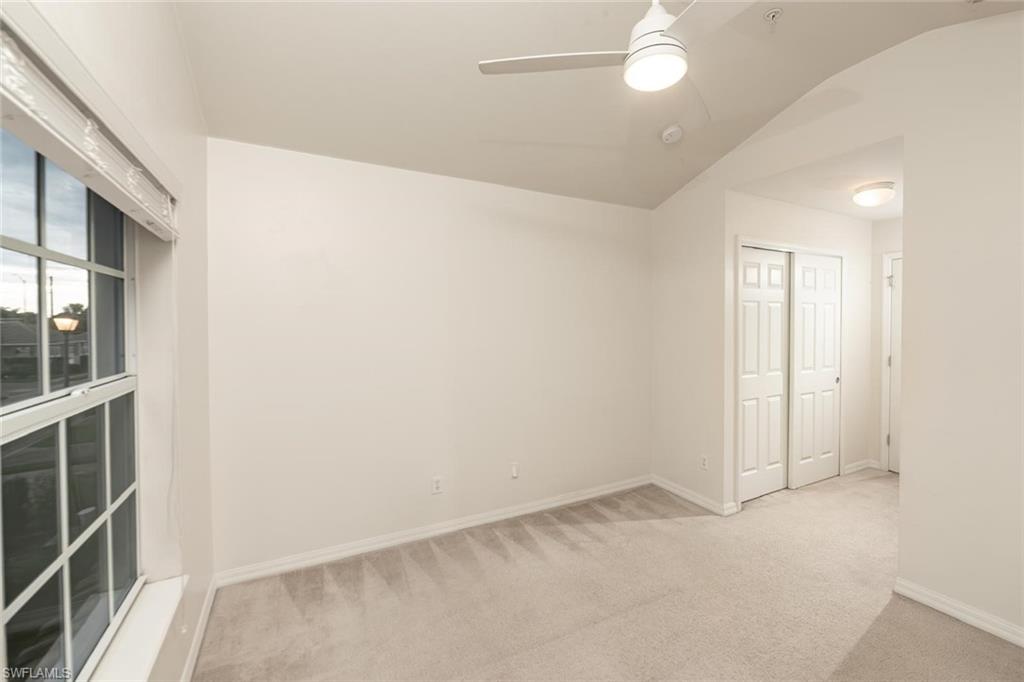 16250 Ravina Way, Unit 87 Naples, FL 34110 - Photo 7 of 15 an empty room with windows and entrance