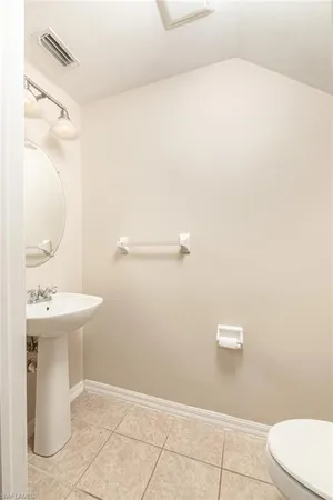 a bathroom with a sink a toilet and mirror