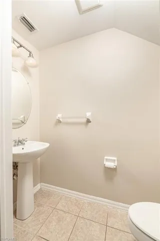 a bathroom with a sink a toilet and mirror