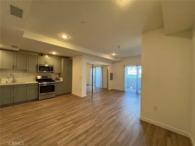 a view of kitchen with sink and stainless steel appliances