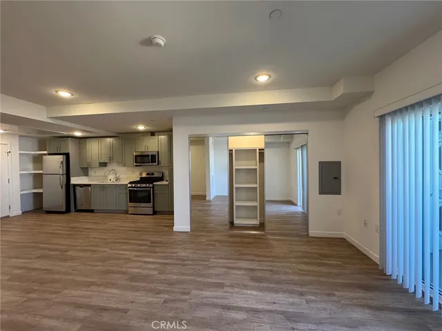 a view of a kitchen with refrigerator and microwave