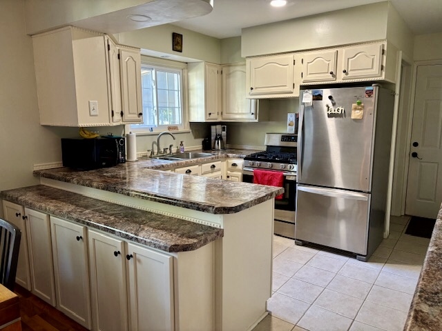 5 Boone Court Normal, IL 61761 - Photo 13 of 29 a kitchen with stainless steel appliances granite countertop a refrigerator a sink and white cabinets