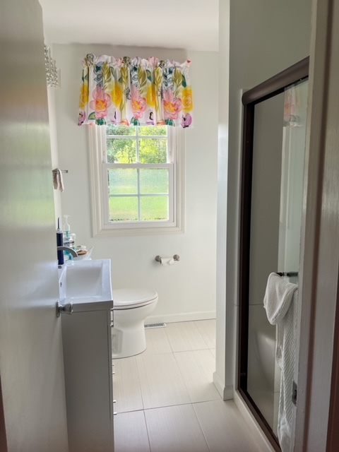 5 Boone Court Normal, IL 61761 - Photo 20 of 29 a bathroom with a toilet sink and mirror