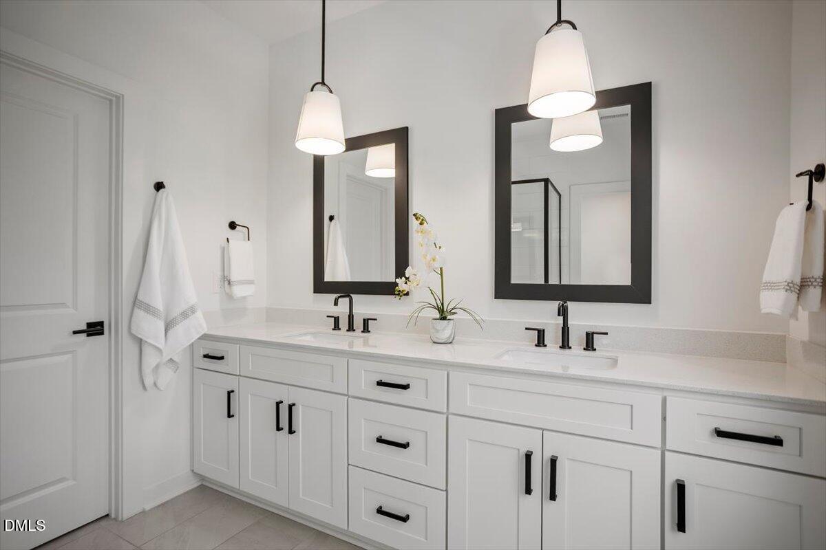 6419 Tanner Oak Lane Raleigh, NC 27613 - Photo 26 of 39 a bathroom with double vanity sink and a mirror