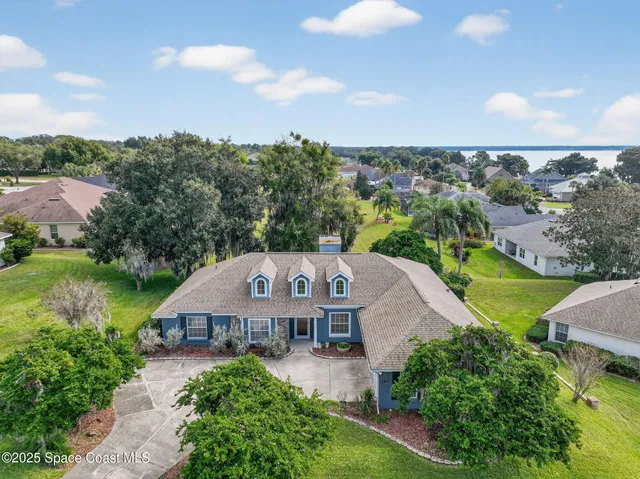 an aerial view of multiple houses with yard