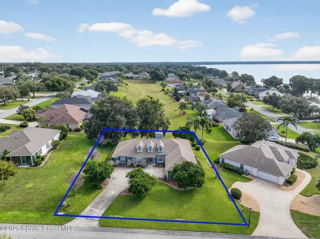 an aerial view of multiple houses with yard
