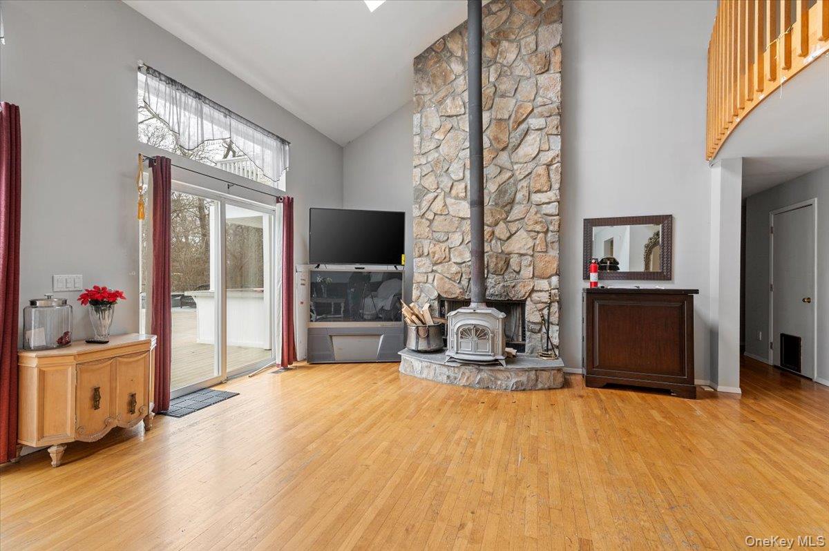 24 Wisteria Drive Remsenburg, NY 11960 - Photo 11 of 44 a living room with a couch and a flat screen tv