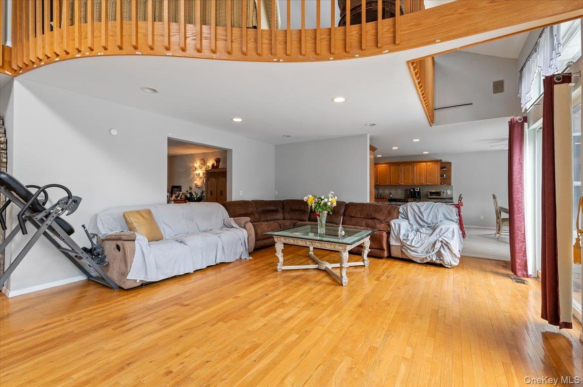24 Wisteria Drive Remsenburg, NY 11960 - Photo 13 of 44 a living room with furniture a flat screen tv and a table